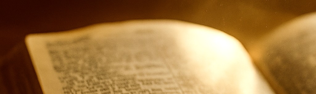 Bible illuminated by light, representing divine truth