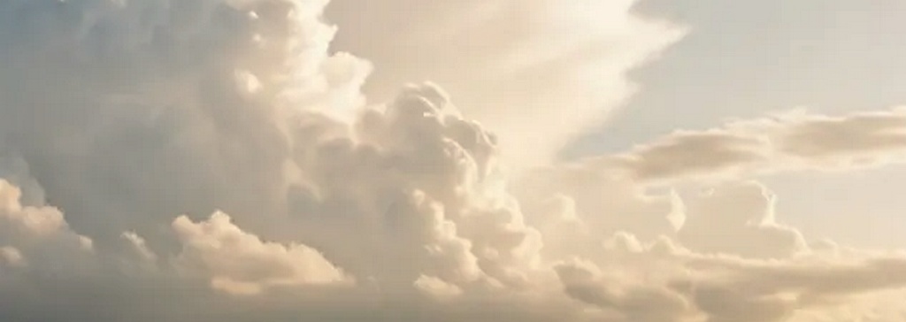 Wide open sky with gentle white clouds and soft heavenly light