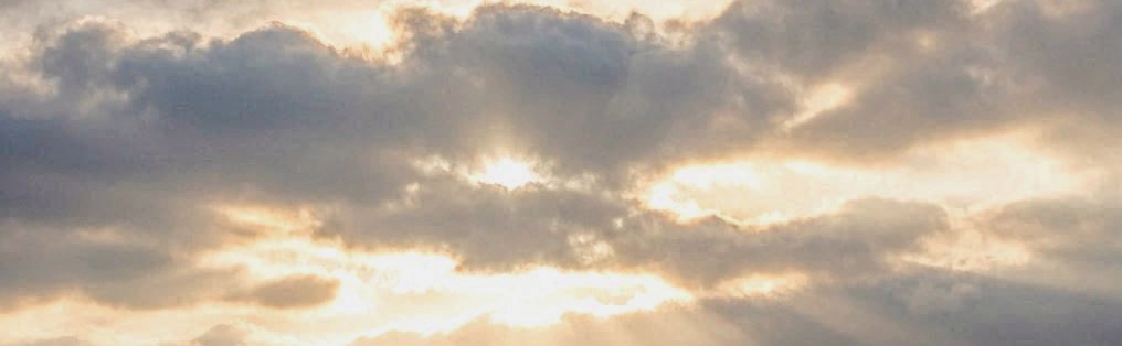 A bright golden pathway leading upward into a radiant heavenly light surrounded by soft clouds, representing the journey toward eternity. 